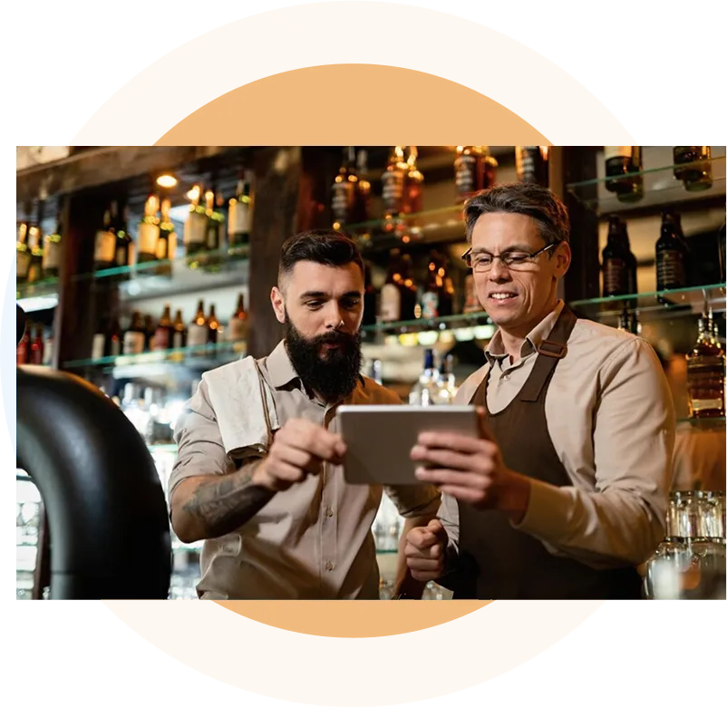 Two restaurant managers looking at a tablet